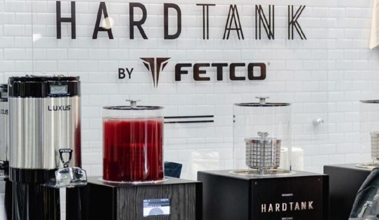 Hardtank is an official partner of FETCO. What does this mean? 5 Three cold brew coffee makers on a countertop.
