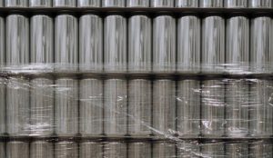 Cans of white label RTD nitro coffee in a warehouse