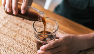A barista pouring a glass of white label cold brew coffee
