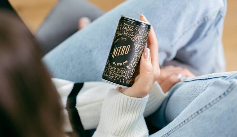 A woman holding a can of healthy white label cold brew coffee