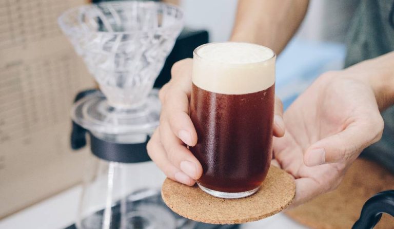 A glass of nitro coffee with foamy head