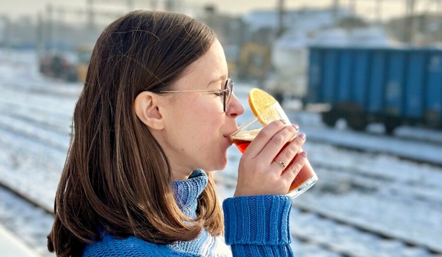 A person drinking a cold brew beverage.