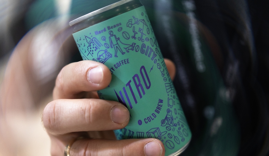 A person holding a canned RTD drink.