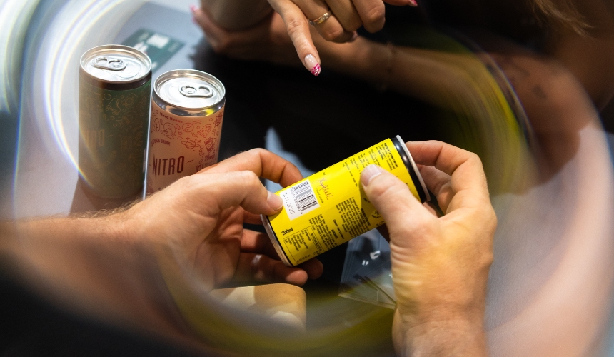 A person holding a canned RTD drink made by private label beverage manufacturers.