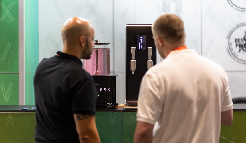 How a nitro brew coffee machine differs from standard equipment (and why it matters) 2 Two people stood in front of a Hardtank nitro brew coffee machine.