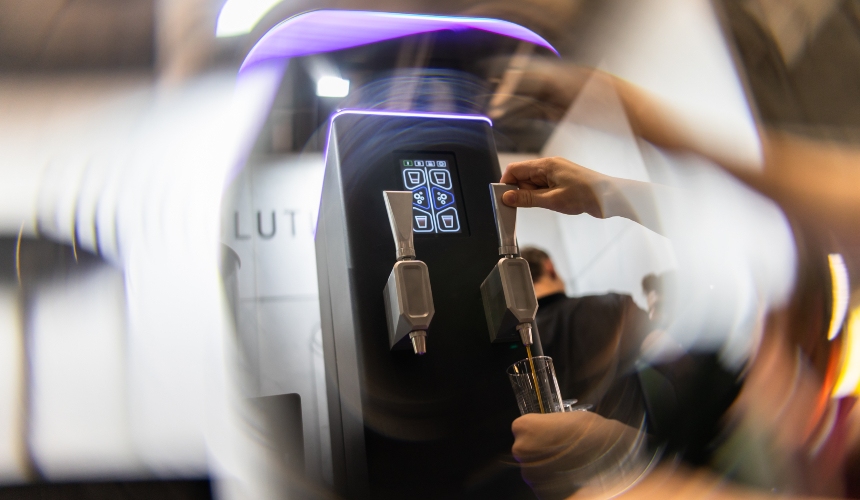 A barista pulling the tap mechanism of a Hardtap nitro cold brew tap.