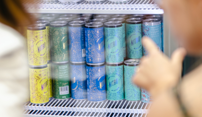 A fridge containing coffee can packaging for nitro cold brew.