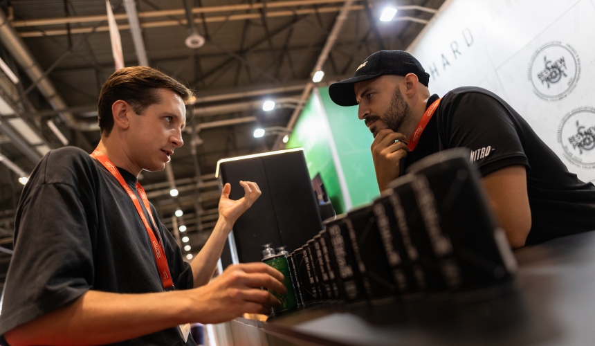 Two people at a trade show speaking about private label RTDs.