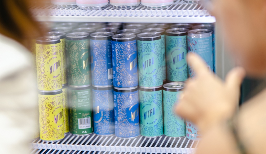 A fridge containing cans of private label ready to drink coffee.