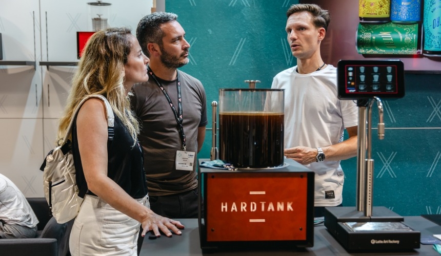 People stood around Hardtank cold brew industrial equipment.