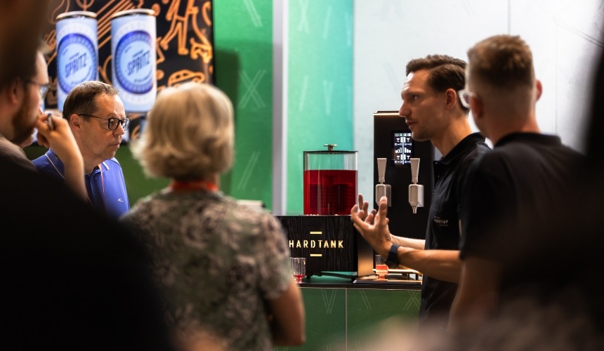 How can a nitro coffee tap reduce waste for coffee shops? 3 People stood around a Hardtap nitro coffee tap.