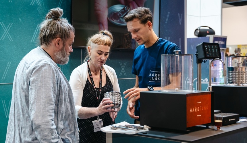What is the best cold brew coffee system for your business? 3 People looking inside the filter basket of a Baby Hardtank.