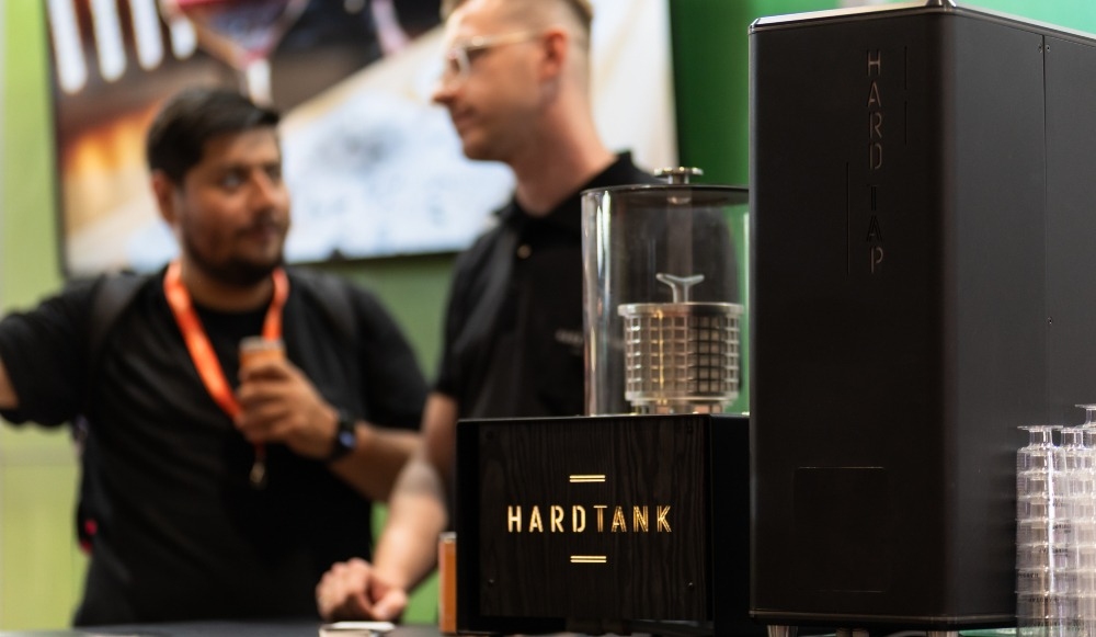Why the best cold brew system combines equipment and private label RTDs 1 Two people stood talking next to a Hardtank cold brew system.