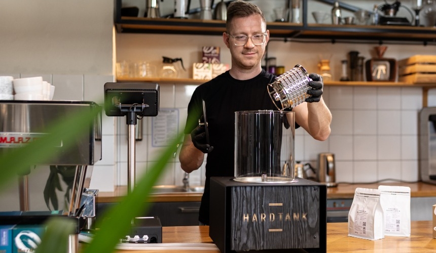 A barista preparing cold brew using a nitro cold brew coffee maker.