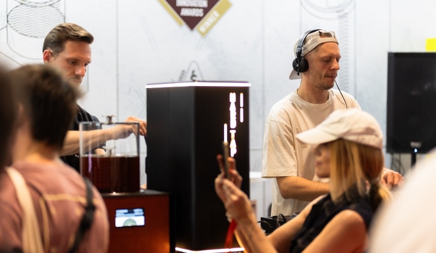 A person pouring drinks from one of Hardtank's espresso martini taps.