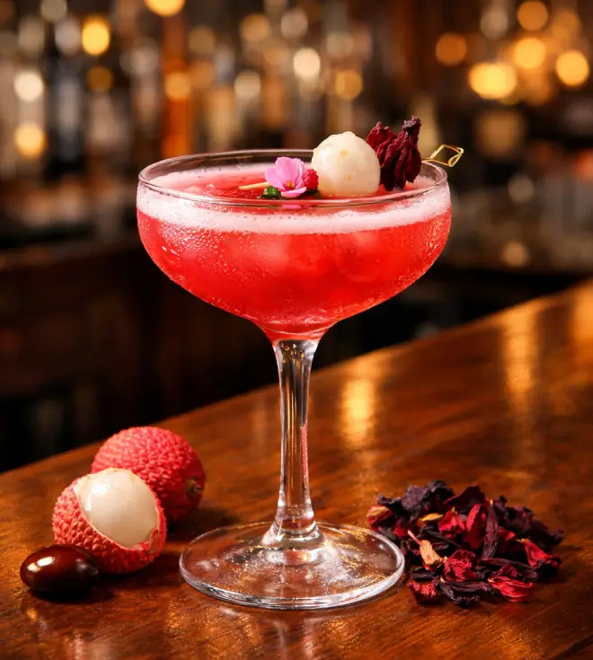 Hibiscus & Lychee Bar Cocktail at a bar.