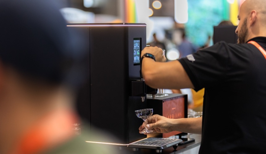 A person pouring a drink from nitro cold brew equipment.