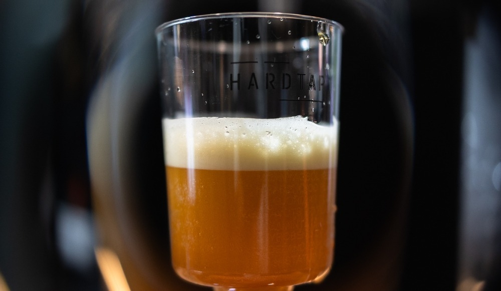 A glass of nitro cold brew prepared using a nitro cold brew system.