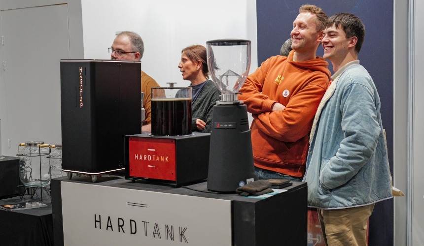 People stood around cold brew systems and dispensers from Hardtank.