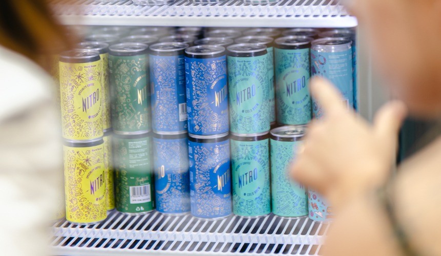 A fridge containing private label canned coffee.