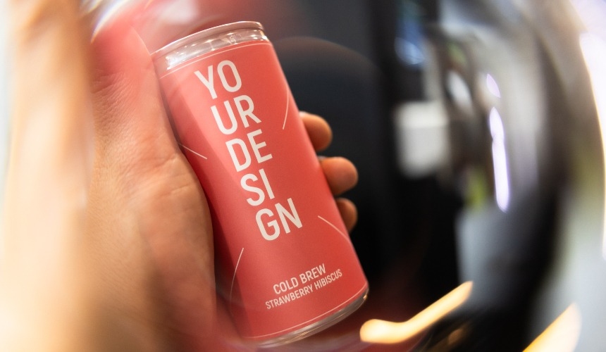 A person holding a can of RTD cold brew.